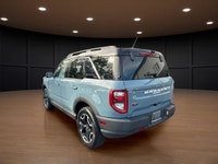 The 2021 Ford Bronco Sport Outer Banks in a striking blue finish with its capable 4x4 drivetrain off... (image 7)
