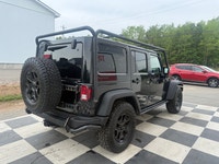 A rugged four-door SUV with iconic styling, manual transmission, and strong 4x4 capability, offering... (image 3)