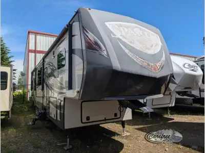 The Spartan 1242X toy hauler fifth wheel by Prime Time Manufacturing has a rear spring assist ramp d...