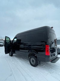 black-on-black Mercedes-Benz Sprinter van. This well-maintained vehicle offers a blend of luxury and... (image 8)