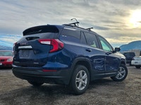 The 2022 GMC Terrain AWD SLE in a captivating Blue shade and equipped with an AWD drivetrain deliver... (image 1)