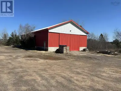 Two large industrial buildings with cement floors, steel roofing and steel walls within sight of Hig...