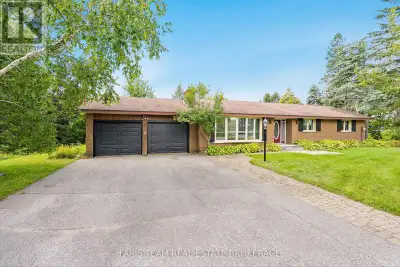 Top 5 Reasons You Will Love This Home: 1) Set on a serene, 6-acre treed lot, this country property o...