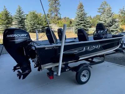 Well maintained 16 ft Lund fishing boat with Shorland'r trailer, depth/fish finder, Bimini top & tra...