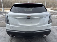 The 2026 Cadillac XT5 Sport AWD, finished in Crystal White Tricoat with a rich Kona Brown interior w... (image 7)
