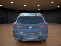 The 2022 BMW X2 xDrive28i Sports Activity Coupe in a sophisticated black finish and equipped with BM... (image 6)