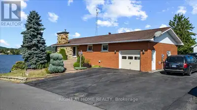 What a View!! Beautiful Landscaped waterfront with a breathtaken view of the Laurentian mountains ....