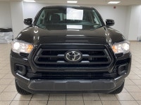 The black paint drinks in daylight like ink, casting sharp reflections across muscular fenders while... (image 7)