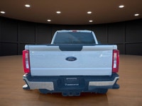 The 2023 Ford Super Duty F-250 SRW XLT in striking white comes equipped with a robust 4x4 drivetrain... (image 6)