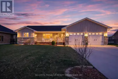 This Port Lambton custom home puts you steps from the river, surrounded by mature landscaping that c...