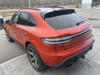 The 2023 Porsche Macan AWD, finished in eye-catching Papaya Metallic, brings true sports car DNA int... (image 4)
