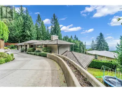 Step into this stunning, gated estate nestled on a vast 36,700 sq. ft. lot in the prestigious Britis...