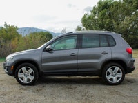 The 2012 Volkswagen Tiguan Highline in its sophisticated gray hue, paired with an agile AWD drivetra... (image 6)