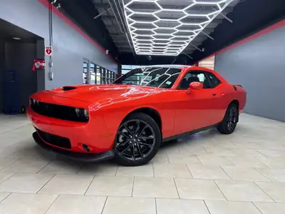Meet the 2022 Dodge Challenger GT in a vibrant orange finish, gracefully combined with an AWD drivet...