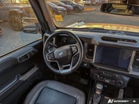 Embrace the spirit of adventure with the 2022 Ford Bronco. This stunning Shadow Black convertible is... (image 9)