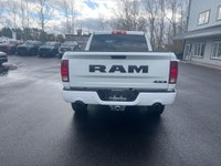 The 2022 Ram 1500 Classic Express, presented in a pristine white finish, is equipped with a robust 4... (image 6)