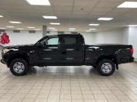 The black paint drinks in daylight like ink, casting sharp reflections across muscular fenders while... (image 2)