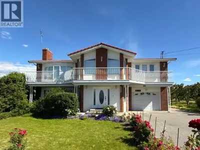 A RARE OSOYOOS COUNTRY ESTATE! Set on approximately 1 acre and surrounded by picturesque orchards an...