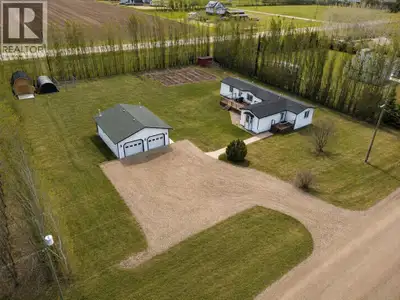 MINT Condition acreage just outside of La Crete. This home is set apart with its meticulous attentio...
