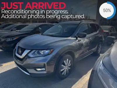 The 2018 Nissan Rogue SV, presented in a sophisticated gray with a robust AWD drivetrain and agile h...