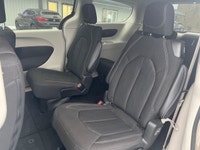 Experience the 2024 Chrysler Grand Caravan SXT in a pristine white finish, complete with efficient f... (image 4)