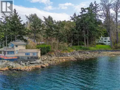 2620 Queenswood Drive sits on a rare waterfront acreage in one of Victoria's most sought-after neigh...