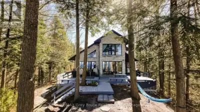 Nestled among the trees and perched on a scenic hilltop, this stunning 2+2 bedroom, 4-bath home offe...
