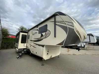 Grand Design Solitude 310GK fifth wheel highlights: Rear Tri-Fold Sofa Kitchen Island Four Door Refr...