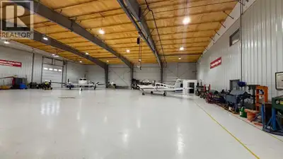 Industrial building used as plane hangar. Features Septic Sewer, Fortis Electrical Power, Gas Line w...