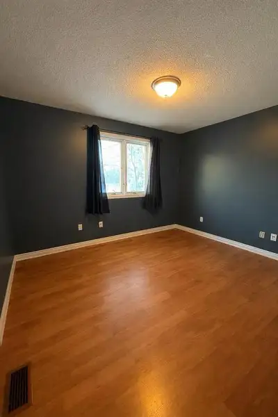 Bright 12x12ft furnished bedroom with closet, modern flooring, and plenty of natural light in a very...