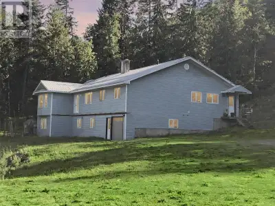 Stunning West Creston property on 5.73 acres with year round creek, great views, covered workshop ar...