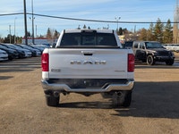 The 2026 Ram 1500 Longhorn Crew Cab in Ivory Tricoat Pearl combines rugged capability with refined l... (image 4)