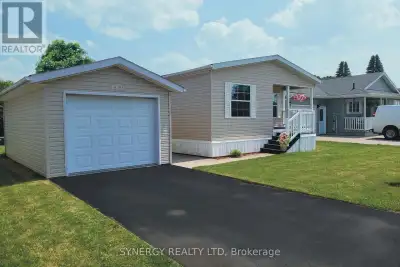 Welcome to serene and stress-free living in this charming detached mobile home located in the Twin E...