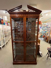 Amazing curio cabinet! Ornate detailing on the top and front