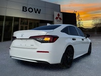 The 2025 Honda Civic Sedan Hybrid Sport in a stunning white finish combined with its FWD drivetrain... (image 4)