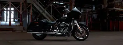 The menacing dual Daymaker Reflector LED headlamps in the Road Glide motorcycle’s shark-nose fairing...