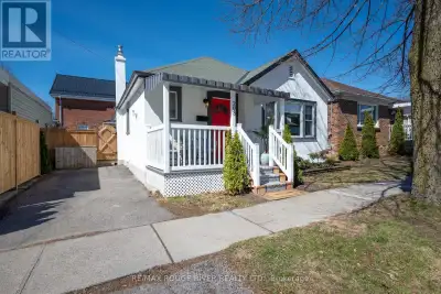 This pretty vintage bungalow graces one of Cobourg's most coveted streets, steps from the beach boar...