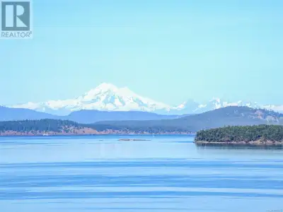 Perched above the coastline on a gently terraced, west-sloping 11-acre parcel, this stunning high-ba...