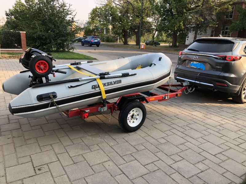 Inflatable boat with an engine and trailer. Powerboats & Motorboats