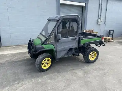 2013 John Deere 825I Gator Utility Vehicle. 1052 hrs. Hyd dump cargo box. Cab enclosure. Enclosure c...