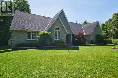 This Custom-built stone home sits on 7 private, forested acres with manicured gardens and an in-law...