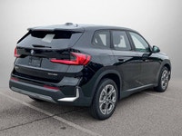 The 2025 BMW X1 xDrive28i arrives as a striking black Sport Utility vehicle, seamlessly blending ath... (image 4)
