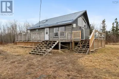 At the very end of a quiet, private lane, tucked away on nearly four acres, sits a log home that fee...