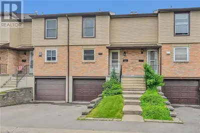 Beautifully kept carpet free and bright town home with patio backing onto a wooded ravine and no nei...