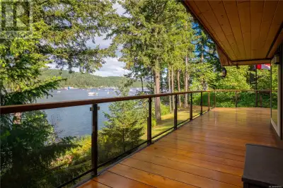 Experience elevated coastal living with this extensively and meticulously renovated high bank oceanf...