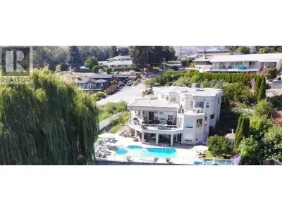 WATERFRONT! Experience exceptional waterfront living in this custom-built home tucked away on a quie...