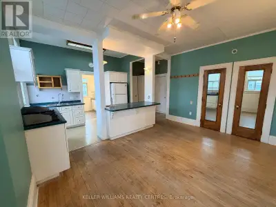 A bright and spacious upper-level residential apartment that spans the full width of the two commerc...