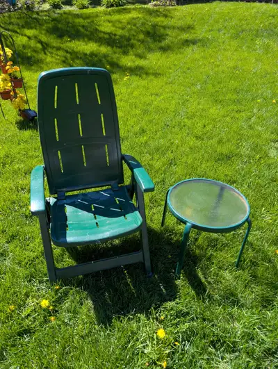 Green adjustable folding chair & matching metal side table with glass top. Cash Only Please call 807...