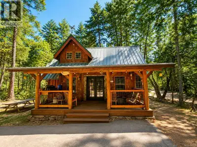 Charming Mudge Island Post and Beam cottage set on an elevated half acre with southwest exposure, ju...