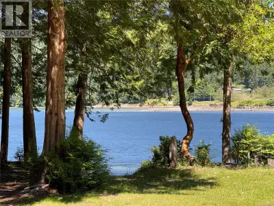 Stunning Walk-On WATERFRONT with a park-like setting featuring a well built Cottage on beautiful Mud...